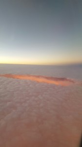 We left at 6:00 a.m. and this was the sun rising through the clouds as we fly home.